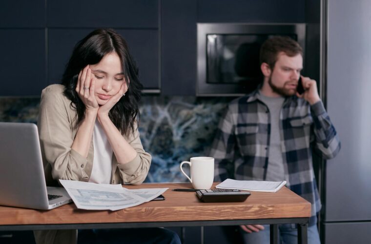 woman in white long sleeve shirt sitting beside man in black and white checkered dress shirt